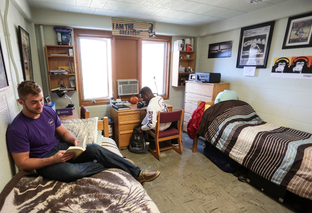 Two students sitting in their dorm